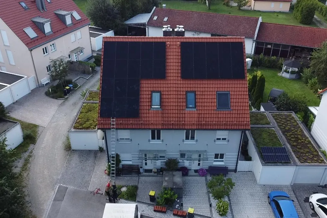 Doppelhaushälfte mit zwei Photovoltaik-Modulfeldern auf rotem Ziegeldach